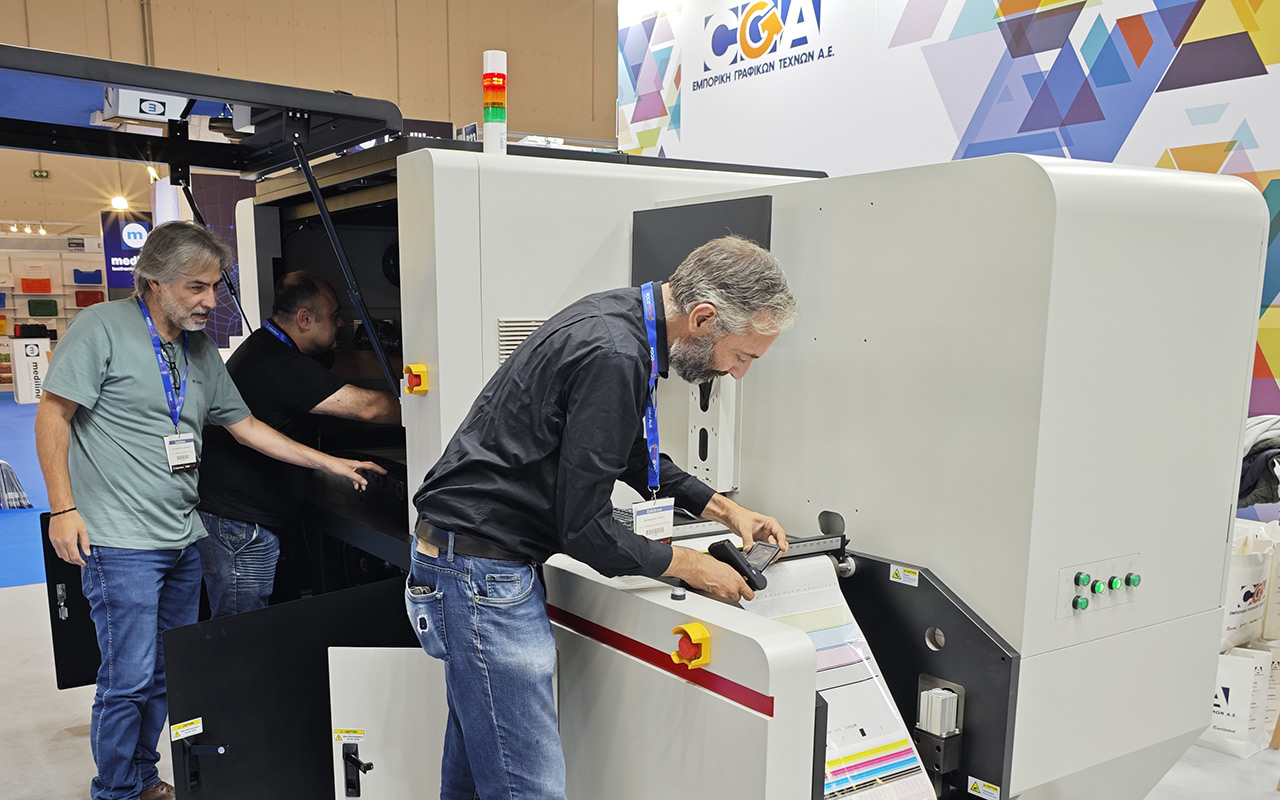 Technician servicing printing equipment